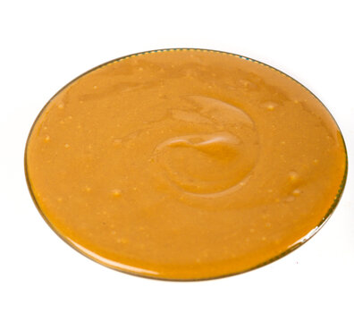 Pure Henan sesame paste in glass bowl - traditional Chinese tahini condiment for cooking and hot pot dip