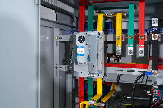 Industrial electrical control cabinet interior with color coded busbars