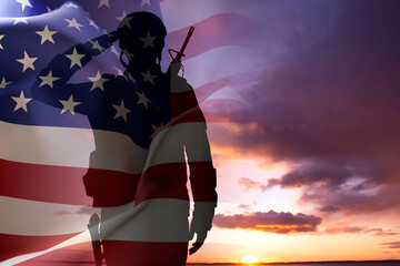 Silhouette of a soldier with USA flag against the sunset. Memorial Day, Veterans Day © ecrow