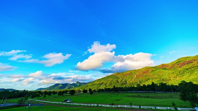 Time lapse panoramic landscape captures the beauty of a tropical mountain region, where expansive forests stretch toward the horizon under dynamic cloud formations. grass mountain in Ranong