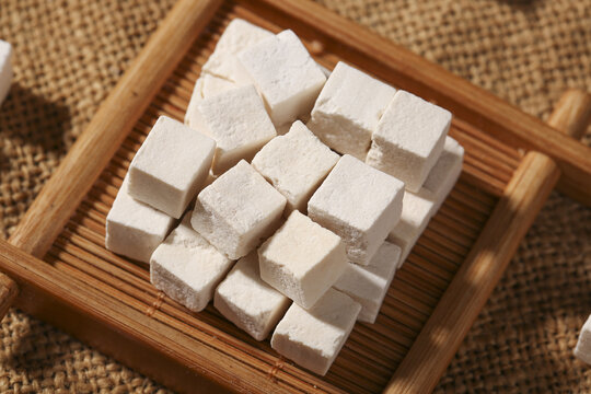 Traditional Poria Cocos Cubes Yunnan Chinese Herbal Medicine on Bamboo Tray Studio Shot