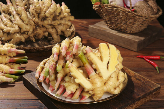 Freshly Dug Yellow Ginger Roots from Luoping Yunnan Mountain Region on Rustic Wooden Board