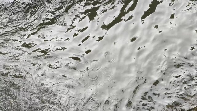 Clear river water flow with calm ripples flowing over natural rocks in the mountainous area of Bandung.