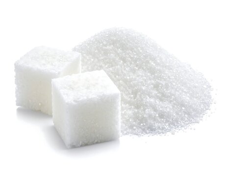 A close-up photo of white sugar cubes and granulated sugar