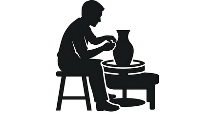 Fototapeta premium Potter working on ceramic vessel in studio silhouette