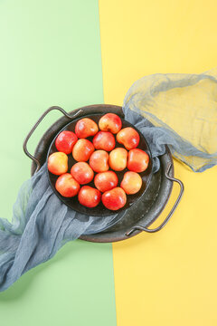 Fresh Golden Rainier Cherries in Cast Iron Pan on Bright Colorful Background