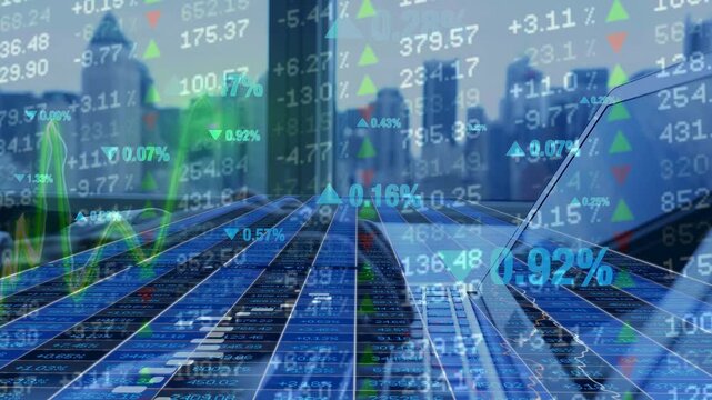 Double exposure of a laptop and city skyline with glowing stock market charts and financial data. Represents digital trading, global economy, and corporate finance concepts.