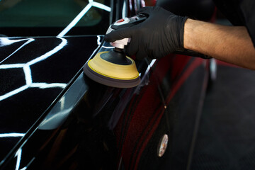 Obraz premium Expert detailing using rotary polishers to remove scratches, restore deep gloss, and protect your vehicle factory finish. Paint Correction and Detailing