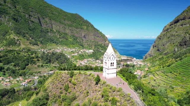 Iconic white clock tower of Chapel of Our Lady of Fatima standing proudly atop Pico da Cova peak in Sao Vicente Madeira