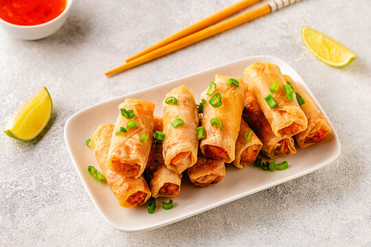 Fried spring rolls served with lime and sauce