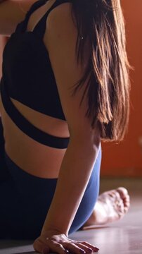 Woman with long hair dancing with pole in a fitness class
