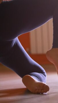 Woman with long hair dancing with pole in a fitness class