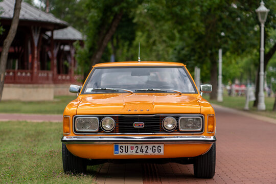 Ford Taunus GT TC1 Coupe 1970s - front view of a classic vintage orange oldtimer car with parked on a walkway in Palic, Serbia on July 5, 2026