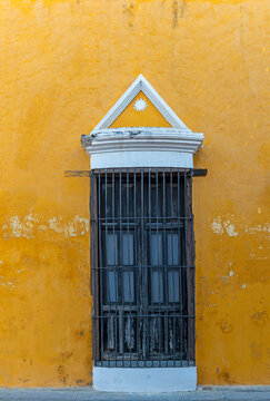 Colonial style facade with window in San Cristobal de las Casas, Chiapas, Mexico.