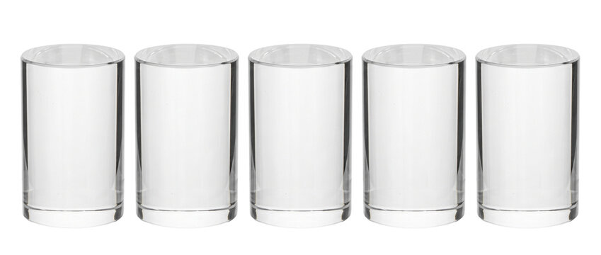 Clear acrylic cylinder display stands lined up on white background for product presentation mockup scenes. Set of five blank transparent glass pedestals and showpieces in modern minimalist studio set.
