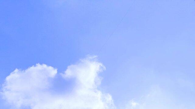 Small White Cloud Floating in Clear Blue Sky Timelapse 4K