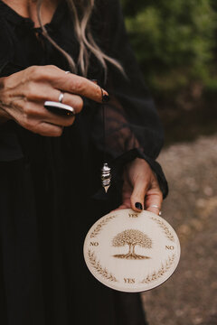 Woman Holding Pendulum