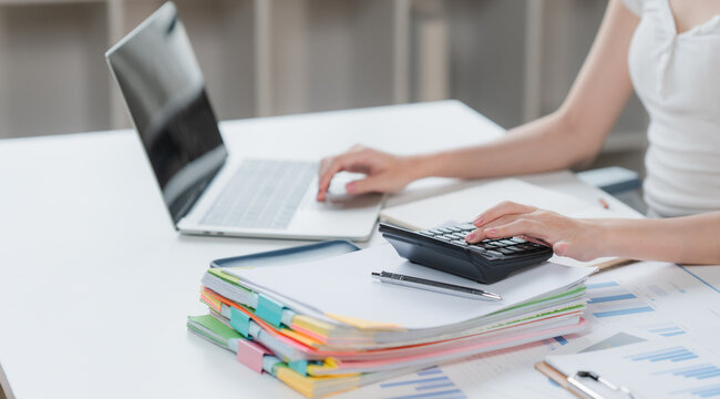 Auditor and accountant team working in office, analyze financial data and accounting record with calculator. Accounting company provide finance and taxation planning for profitable cash flow. Insight	