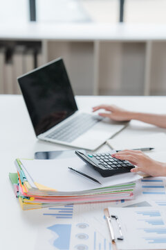 Auditor and accountant team working in office, analyze financial data and accounting record with calculator. Accounting company provide finance and taxation planning for profitable cash flow. Insight	