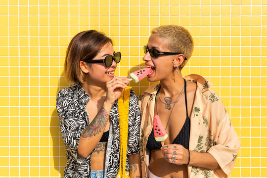 Beautiful multiethnic lesbian couple of lovers dating outdoors - LGBT people bonding and spending time together, concepts about LGBTQ community, diversity, love and lifestyle
