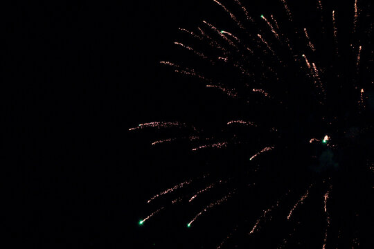 fireworks fading into the night sky with copy space