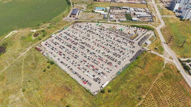 Aerial view of a car impound lot with damaged cars after an accident or towed for illegal parking.