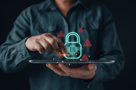 Man touching a tablet with a glowing AI padlock hologram and red warning signs. Concept of artificial intelligence security, cyber threat detection, and data protection technology.