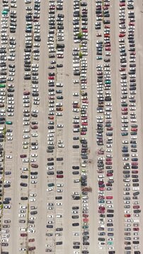 Aerial view of a car impound lot with damaged cars after an accident or towed for illegal parking.