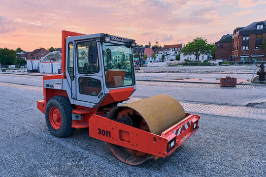 Road construction and infrastructure development, Hamm compactor on a building site in Schleswig, Germany at sunset, heavy machinery, urban planning