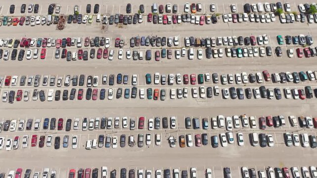 Aerial view of a car impound lot with damaged cars after an accident or towed for illegal parking.