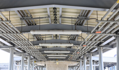 Fototapeta premium electrical steel pipeline, Electrical cable wire way on wall, cable routing between electrical distribution panel with equipment, industry construction concept background.