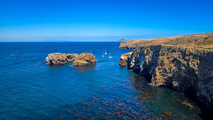 Fototapeta premium Anacapa Island sea cliffs and sailboats in Channel Islands National Pa