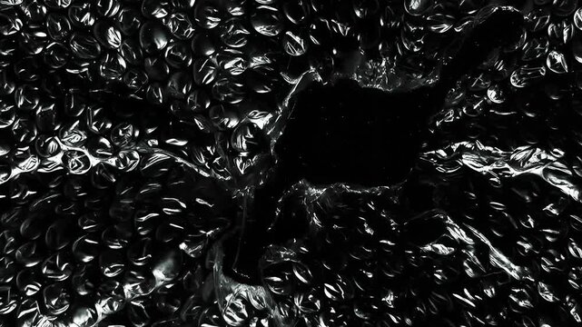 Realistic Bubble Wrap Plastic Texture with Central Torn Opening, Wrinkled Transparent Packaging Film Background Animation for Product Mockups and Motion Graphics Projects