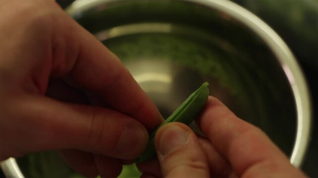 Step by step tutorial of opening fresh green pea pod