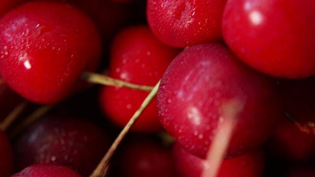 Macro shot of moving sweet cherries showing detailed skin texture
