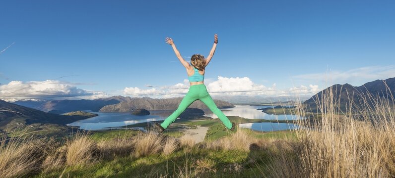 Woman cutting a caper, View of Lake Wanaka, Rocky Peak, Rocky Peak Park, Otago, Southland, New Zealand