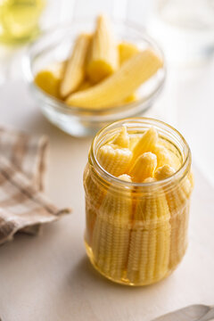 Pickled Baby Corn in a Glass Jar Preserved in Brine on a Bright Kitchen Surface