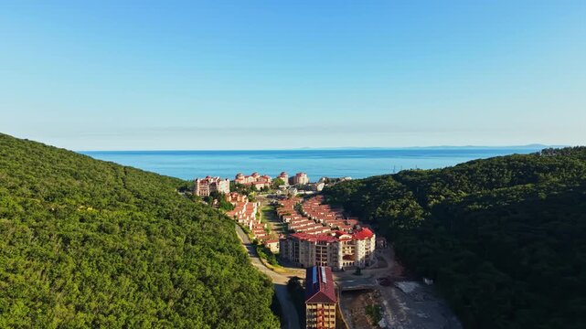 The city of Elenite is seen after a flood has impacted the area, showing damaged structures along the coast. The landscape is altered with water marks.