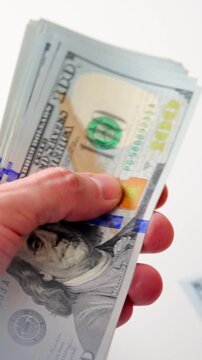 Male hands counting US Dollar bills, close-up