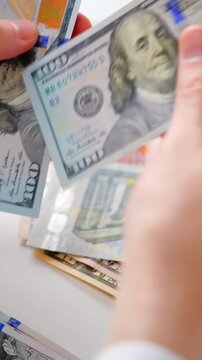 Male hands counting US Dollar bills, close-up