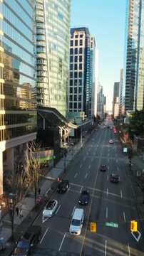 Flight between skyscrapers along the street in Downtown of Vancouver