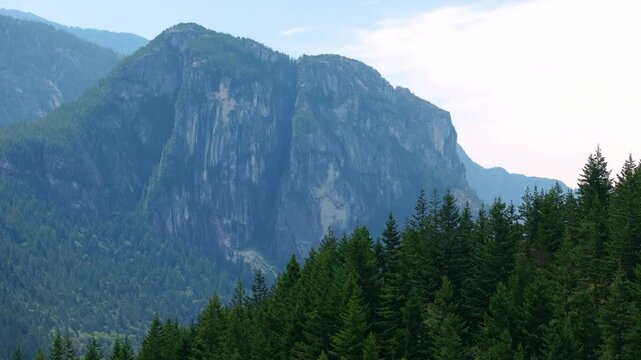 Drone Pan Across The Chief Mountain Behind Forested Ridge in Squamish