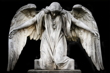 Obraz premium A marble angel statue stands praying beneath on black. Spiritual guardian of faith, devotion, hope, protection, memorial, serenity and religious art. Funeral, burial.