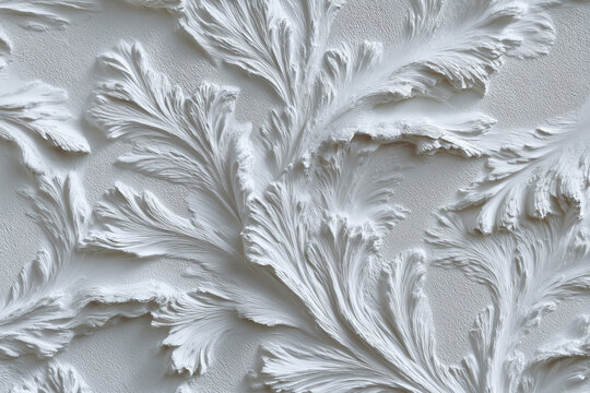 Ornamental floral plaster relief with scrollwork on a seamless white surface. Architectural texture for interior design, minimalism, decor, pattern, restoration, art, background, wallpaper.
