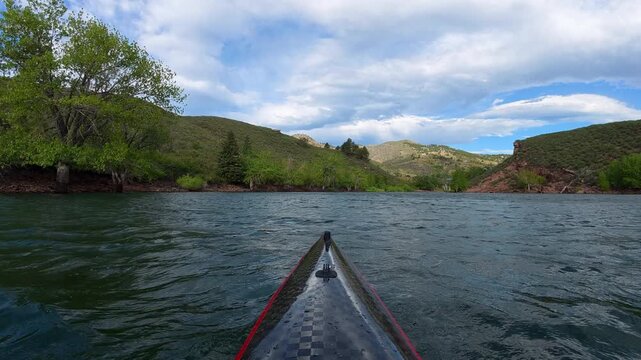 Immersive POV kayaking across Horsetooth Reservoir in Fort Collins, Colorado, while paddling into a strong headwind. Experience challenging summer conditions as a carbon fiber kayak cuts through waves