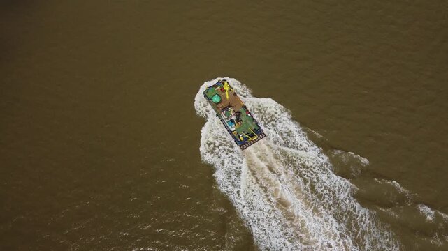 Drone view of a mini dredger carrying out maintenance work on the River Humber. 