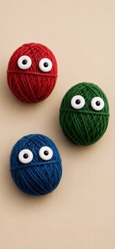 Cute Colorful Yarn Ball Characters with Googly Eyes on Minimal Background