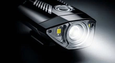 Sleek black bicycle LED headlight with innovative aerodynamic design and powerful crisp illumination, studio product shot © SashaMagic