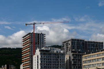 Fototapeta premium Construction Crane Above Residential High-Rise Buildings