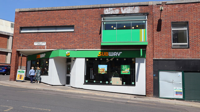 Norwich, United Kingdom - July 5, 2026: General street view in Norwich city centre Vibrant subway restaurant on a busy urban corner with pedestrians